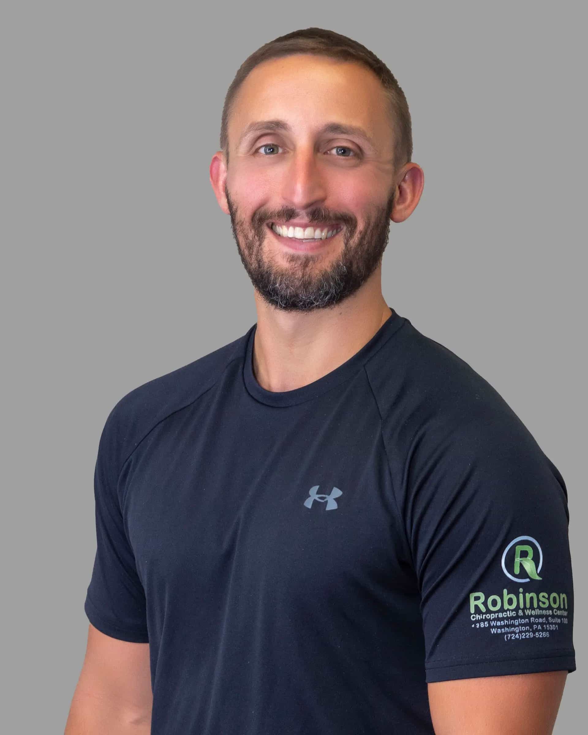 Meet Dr. Marcus Robinson — Your Experienced Chiropractor and Wellness Specialist in Washington, PA Dr Marcus Robinson chiropractor in Washington PA smiling in clinic portrait
